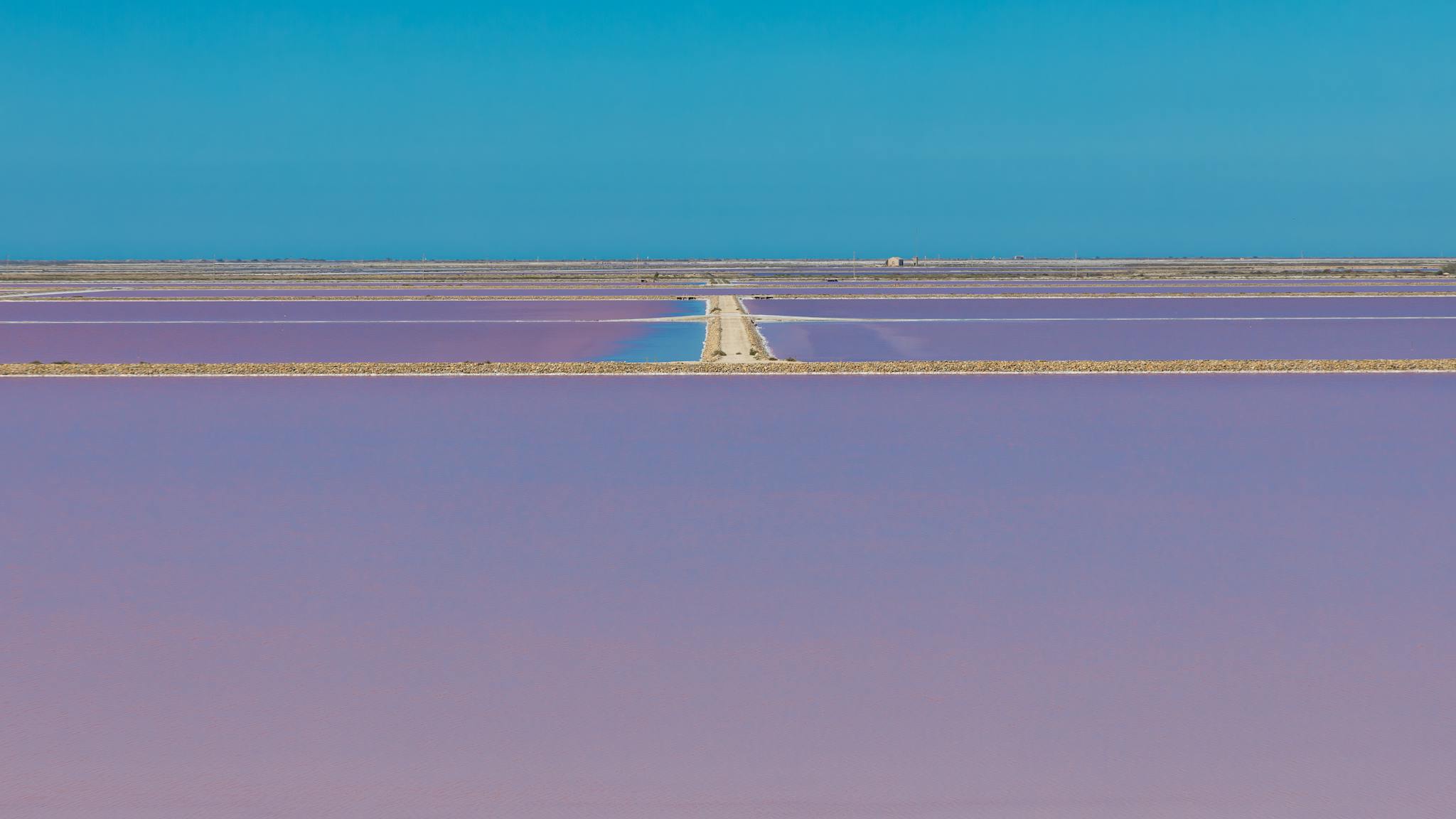 Stunning aerial view of purple salt pans in Saintes-Maries-de-la-Mer, France.